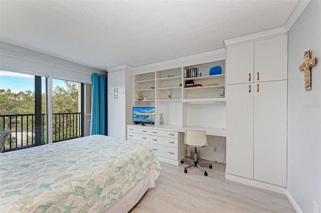 bedroom with ornamental molding, a textured ceiling, light wood-type flooring, and access to outside