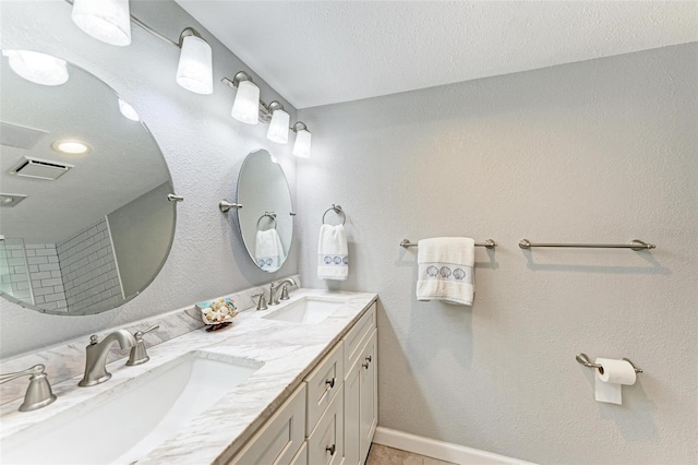 bathroom with vanity and a textured ceiling