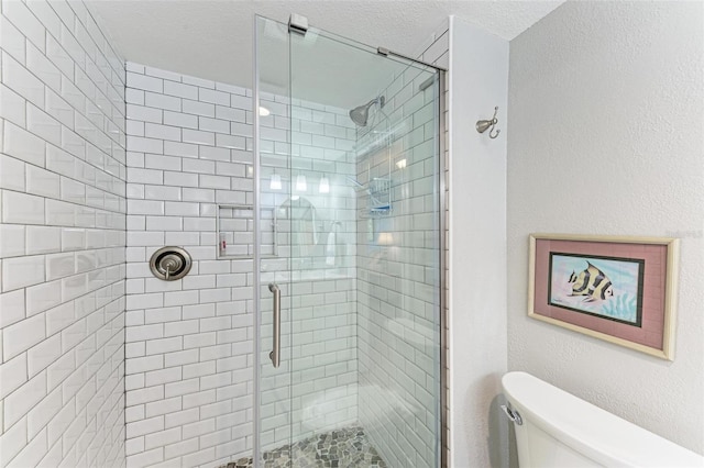 bathroom with toilet, a textured ceiling, and walk in shower