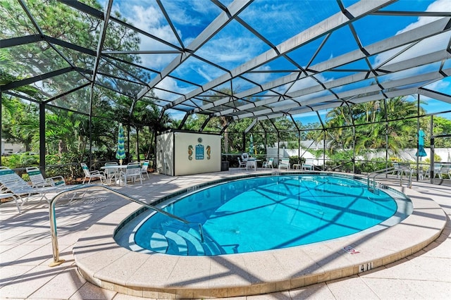 view of swimming pool with a patio and glass enclosure