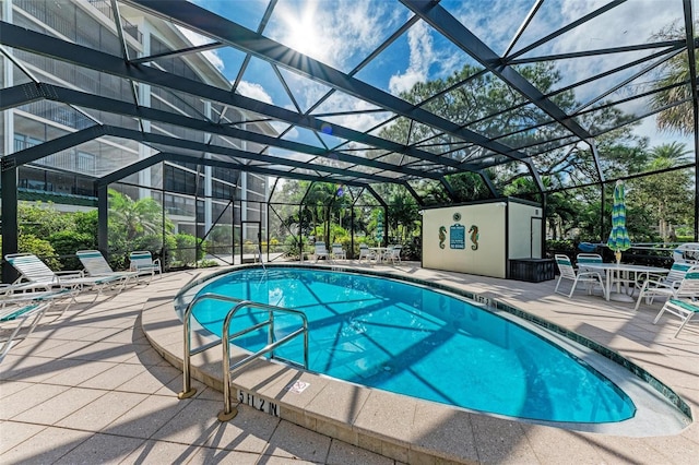 view of swimming pool featuring a patio and glass enclosure