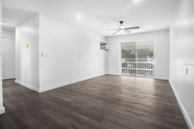 spare room featuring ceiling fan, dark wood-type flooring, and an AC wall unit