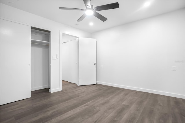 unfurnished bedroom with a closet, ceiling fan, and dark hardwood / wood-style floors