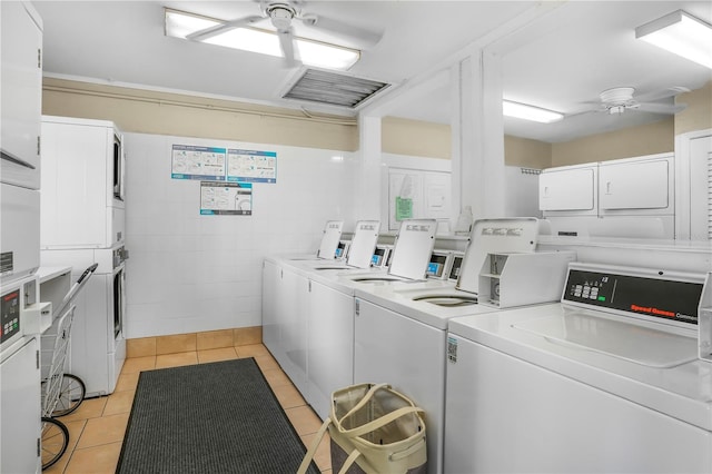 washroom featuring tile walls, light tile patterned flooring, separate washer and dryer, stacked washer / dryer, and ceiling fan