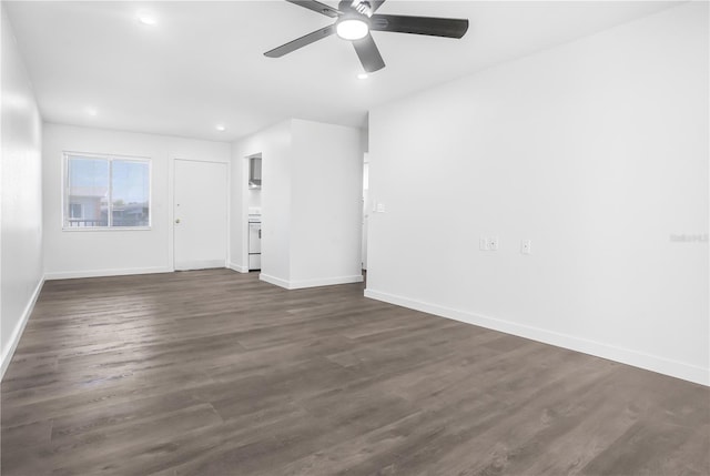 unfurnished living room featuring ceiling fan and dark wood-type flooring