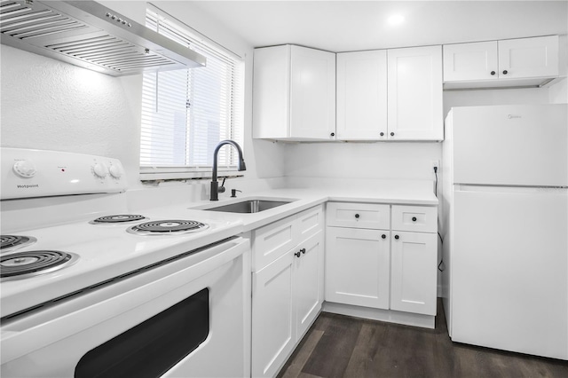 kitchen with white cabinets, white appliances, dark hardwood / wood-style flooring, sink, and wall chimney range hood