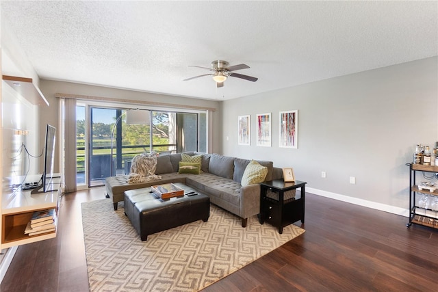 living room featuring ceiling fan, a textured ceiling, and light hardwood / wood-style floors