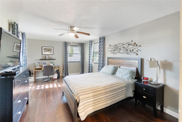 bedroom featuring a textured ceiling, ceiling fan, and dark hardwood / wood-style flooring