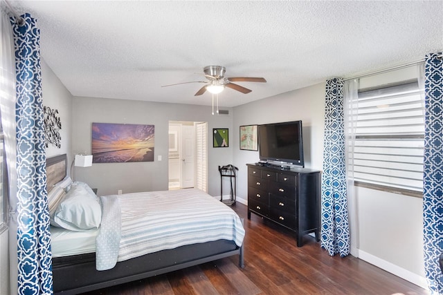 bedroom featuring ceiling fan, a textured ceiling, and dark hardwood / wood-style flooring