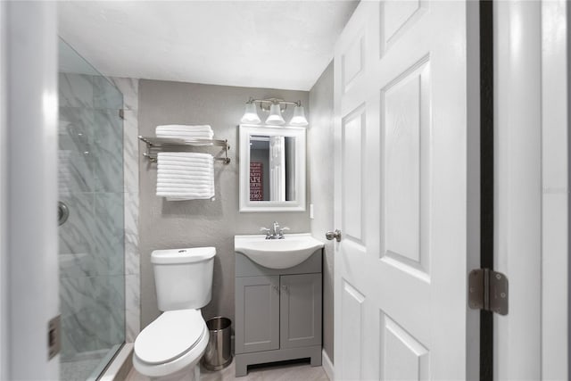 bathroom with vanity, toilet, and a shower with shower door