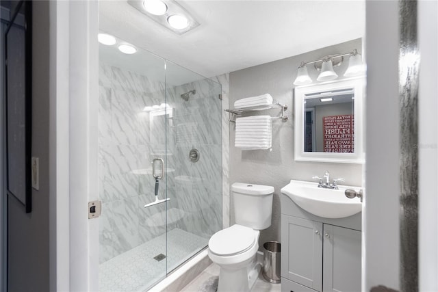 bathroom featuring walk in shower, vanity, and toilet