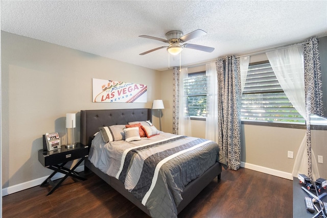 bedroom with a textured ceiling, dark hardwood / wood-style floors, and ceiling fan