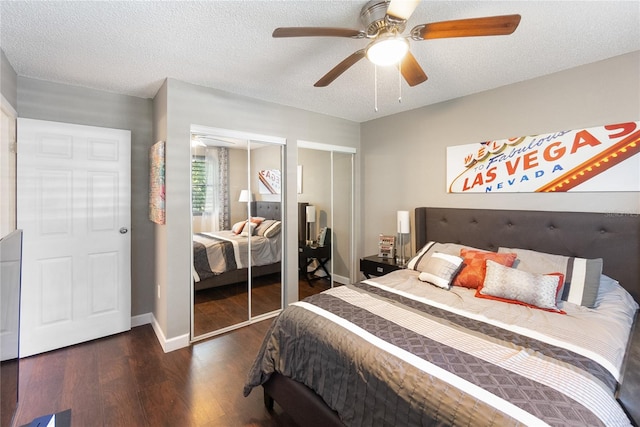 bedroom with ceiling fan, a textured ceiling, and dark hardwood / wood-style flooring