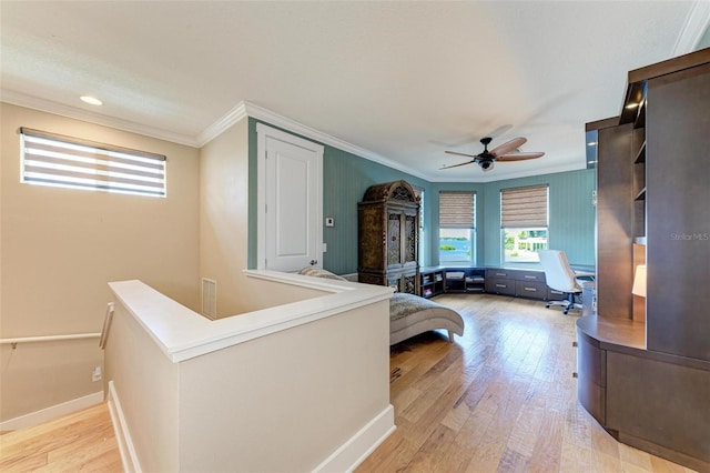 bedroom featuring ceiling fan, light wood-type flooring, and crown molding