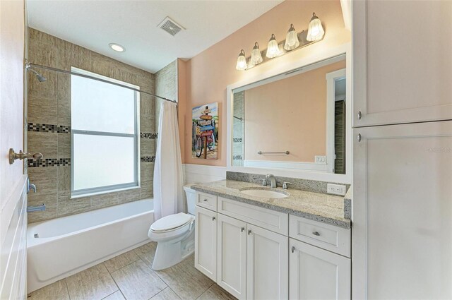 full bathroom with vanity, tile patterned flooring, shower / tub combo, and toilet