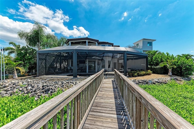 back of house featuring a patio and glass enclosure