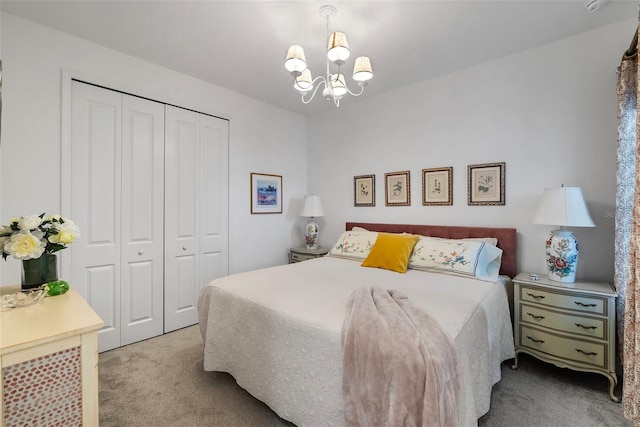 carpeted bedroom featuring a closet and a chandelier