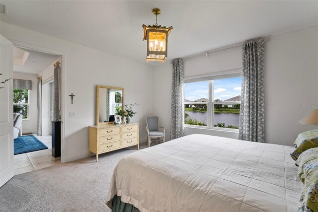 carpeted bedroom with a water view