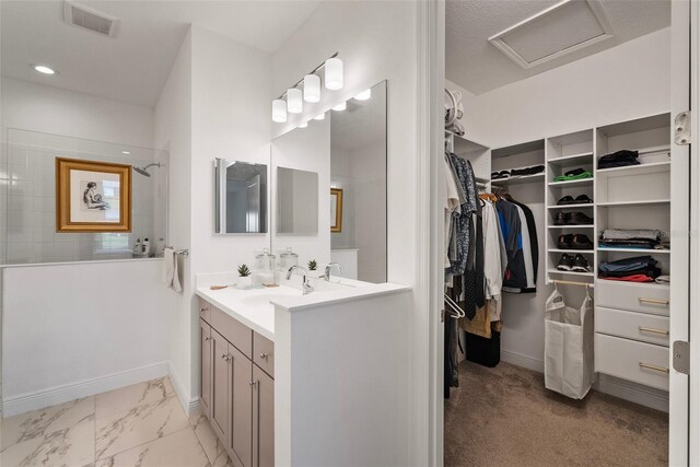 bathroom featuring vanity and a tile shower