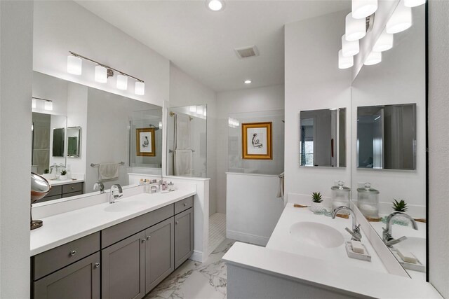 bathroom with vanity and tiled shower