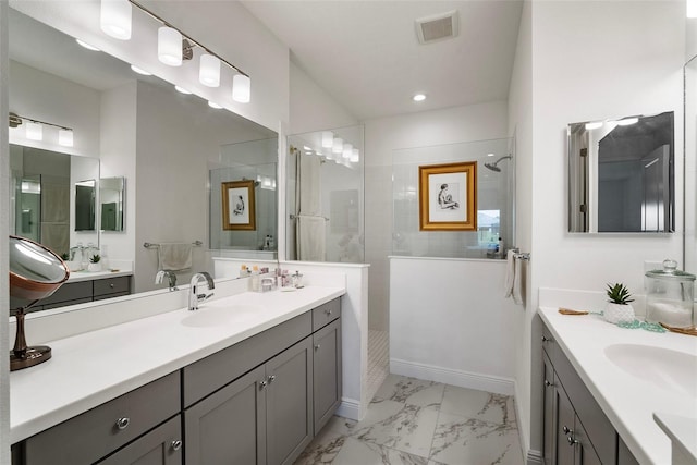 bathroom featuring a tile shower and vanity