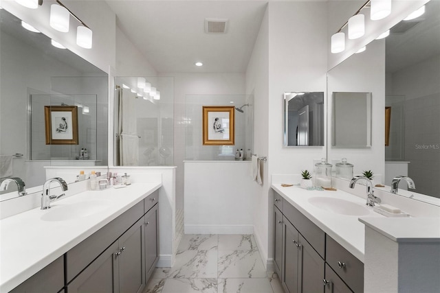 bathroom featuring vanity and tiled shower