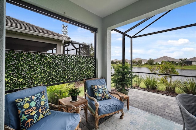 sunroom / solarium featuring a water view