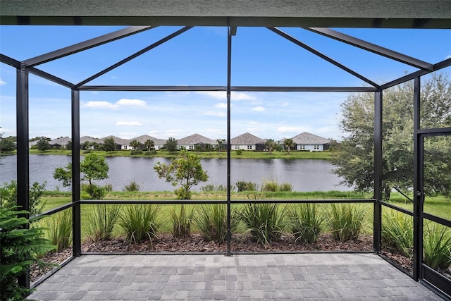 unfurnished sunroom featuring a water view