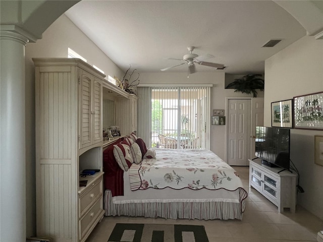 tiled bedroom with a closet, ceiling fan, and ornate columns