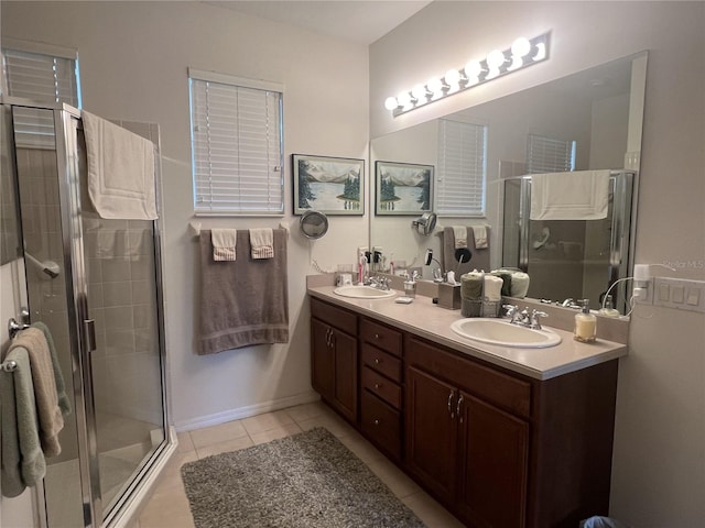 bathroom featuring tile patterned floors, a shower with shower door, and vanity