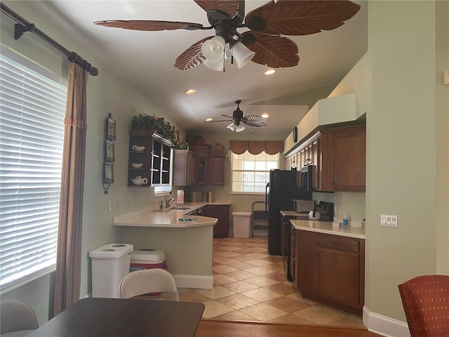 kitchen featuring electric range oven, vaulted ceiling, ceiling fan, and sink