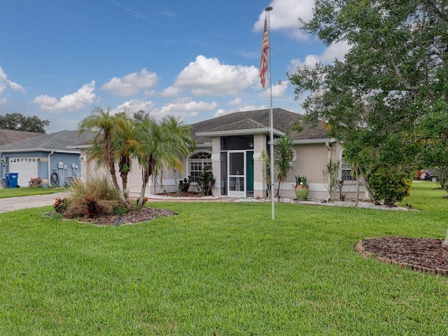 single story home featuring a front lawn and a garage