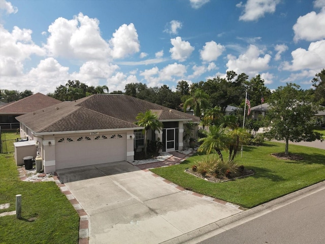 single story home featuring a garage and a front lawn