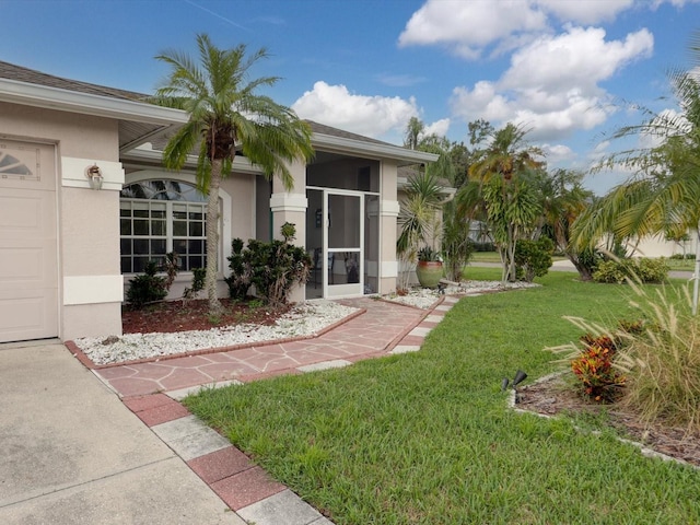 entrance to property with a lawn