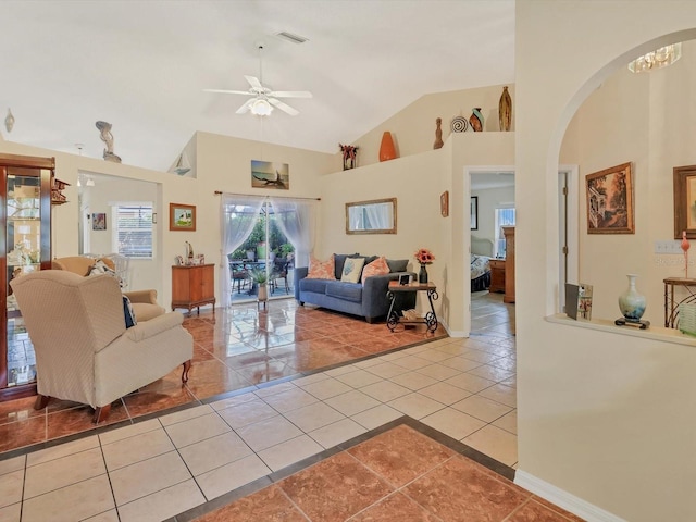 tiled living room with high vaulted ceiling and ceiling fan