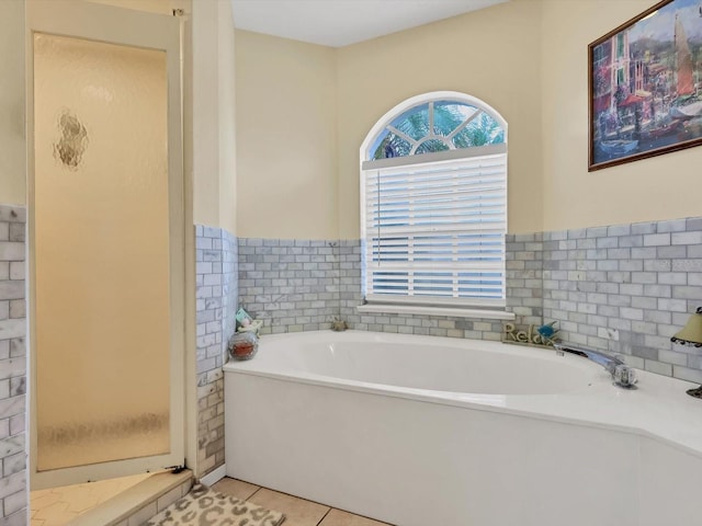 bathroom featuring tile patterned flooring and plus walk in shower