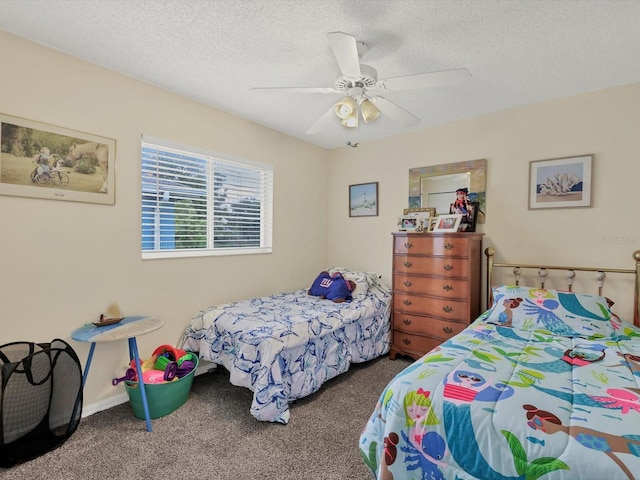 carpeted bedroom featuring ceiling fan and a textured ceiling