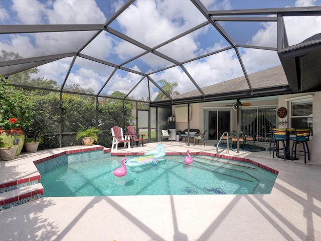 view of swimming pool featuring a lanai, a patio area, and ceiling fan