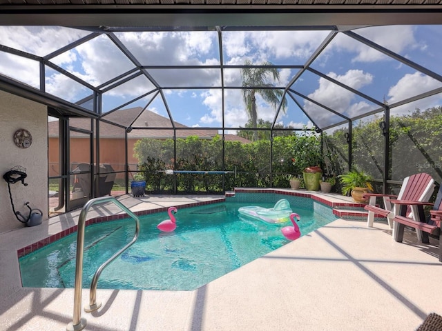 view of swimming pool featuring a patio area and a lanai