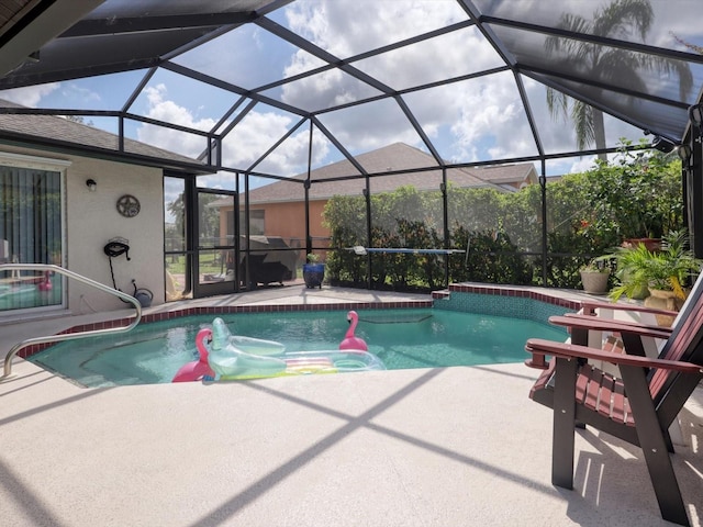 view of swimming pool featuring a lanai and a patio area