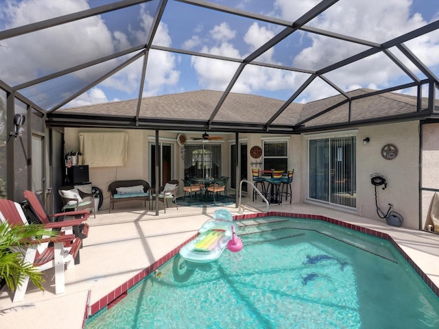 view of swimming pool with a lanai, a patio area, and ceiling fan