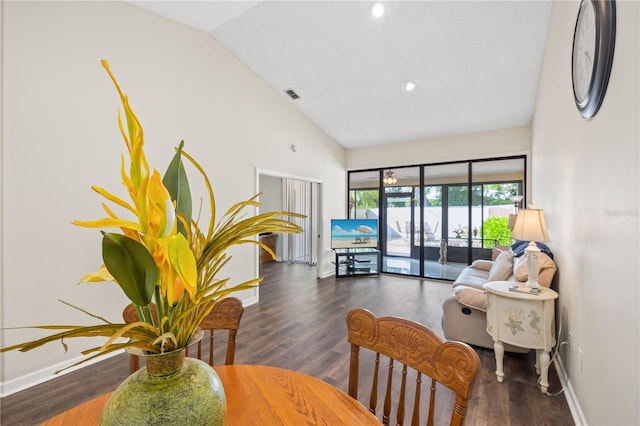 living room featuring vaulted ceiling and dark hardwood / wood-style flooring