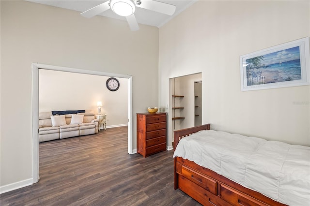 bedroom with a high ceiling, dark hardwood / wood-style floors, and ceiling fan