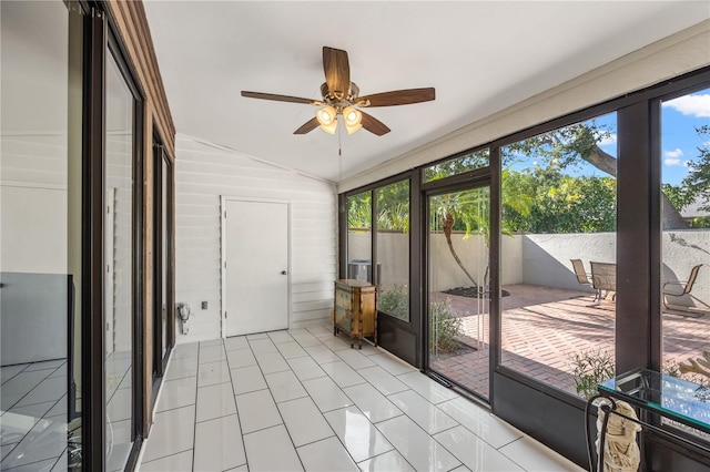 sunroom featuring vaulted ceiling, ceiling fan, and a wealth of natural light