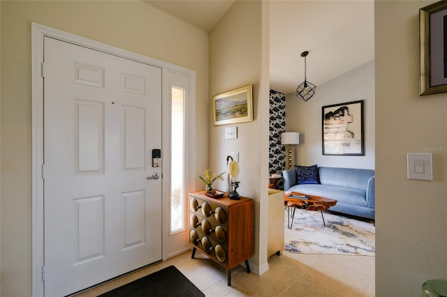 tiled foyer entrance featuring lofted ceiling