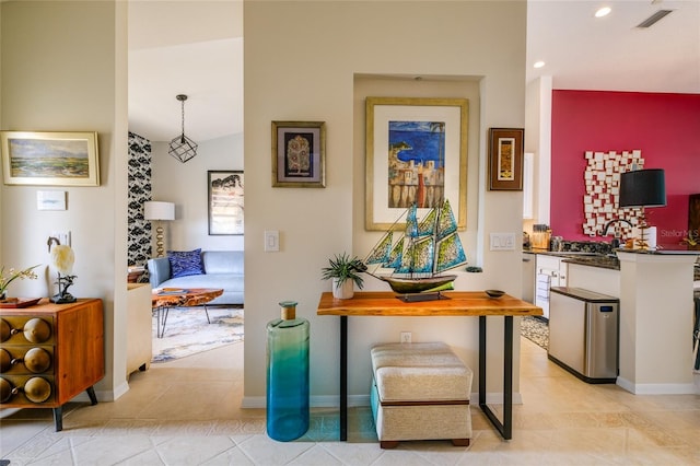 corridor featuring vaulted ceiling, sink, and light tile patterned floors