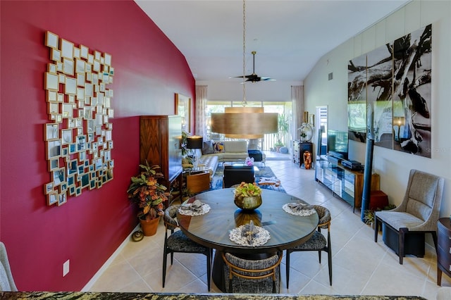 tiled dining room with ceiling fan and lofted ceiling