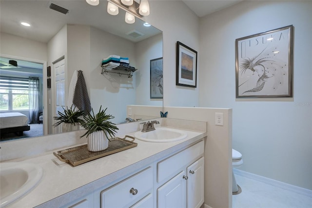 bathroom featuring tile patterned flooring, vanity, and toilet