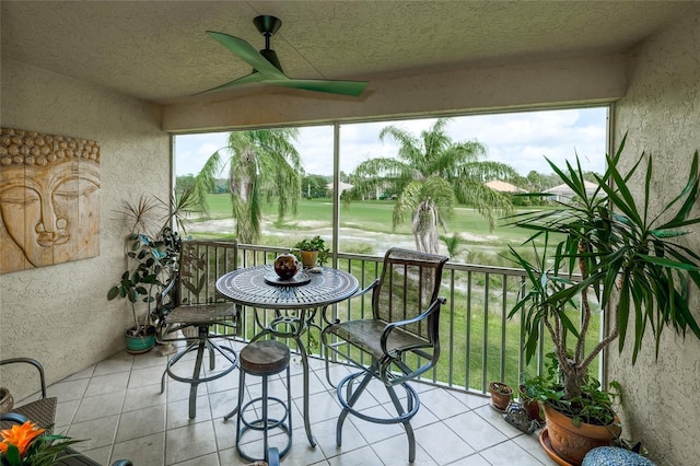 sunroom / solarium featuring ceiling fan