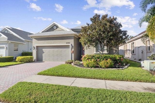 view of front of house with a garage and a front lawn